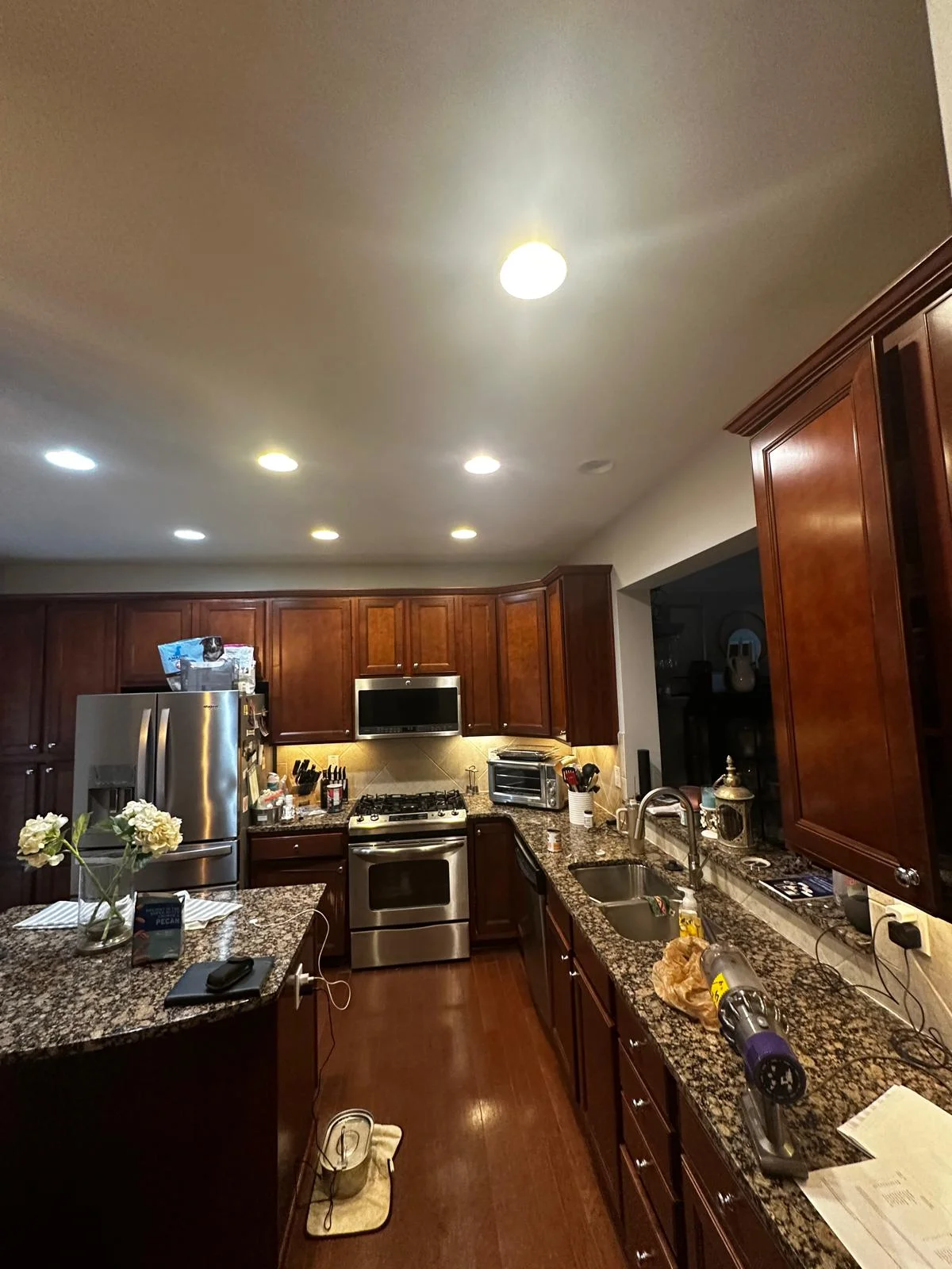 Kitchen before remodel — dark cherry cabinets and dated countertops